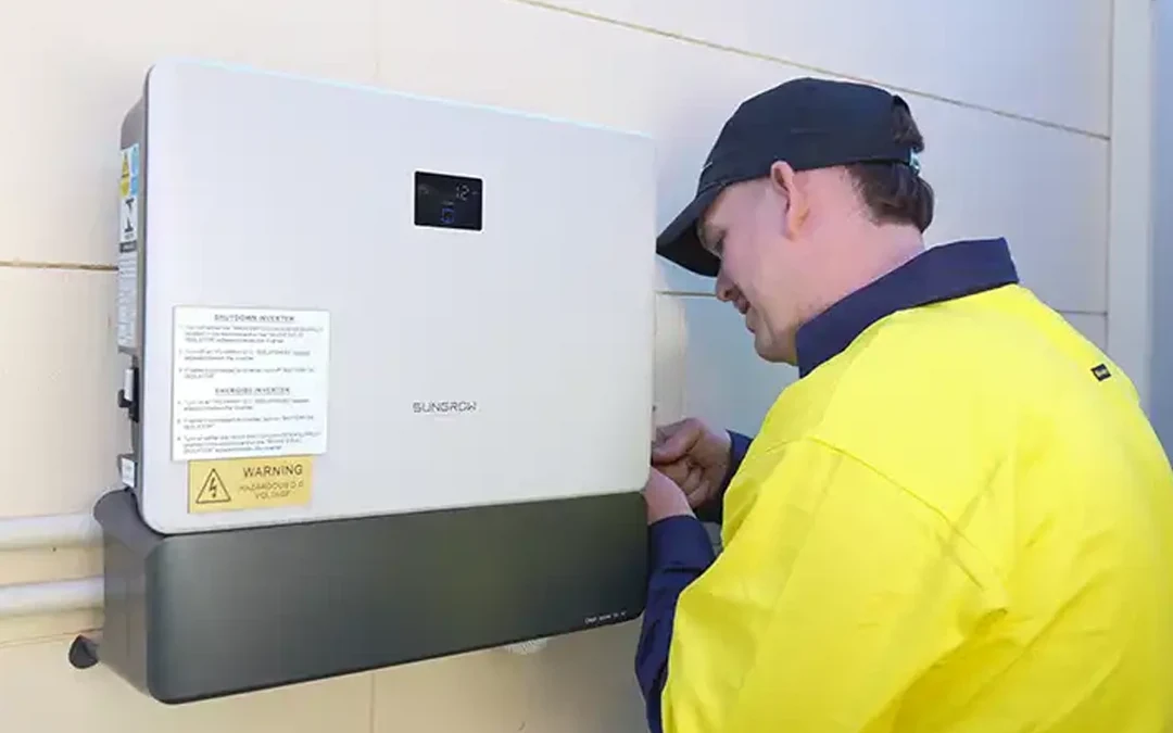 Licensed electrician fault-finding a solar inverter